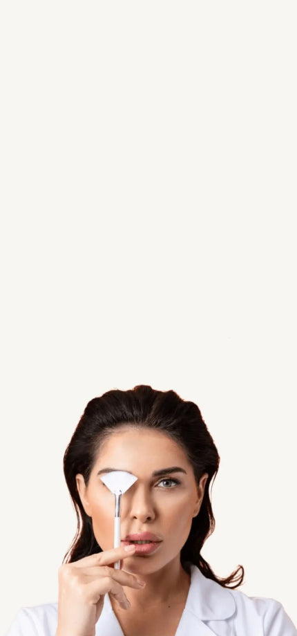 a female beautician with a brush near her eyes